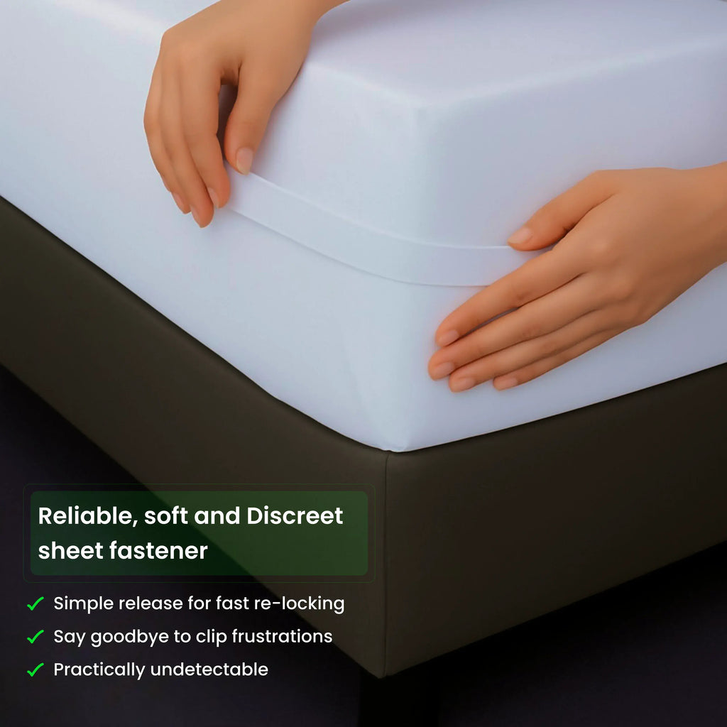 Hands fixing a bed sheet using a discreet white sheet fastener on a mattress corner.